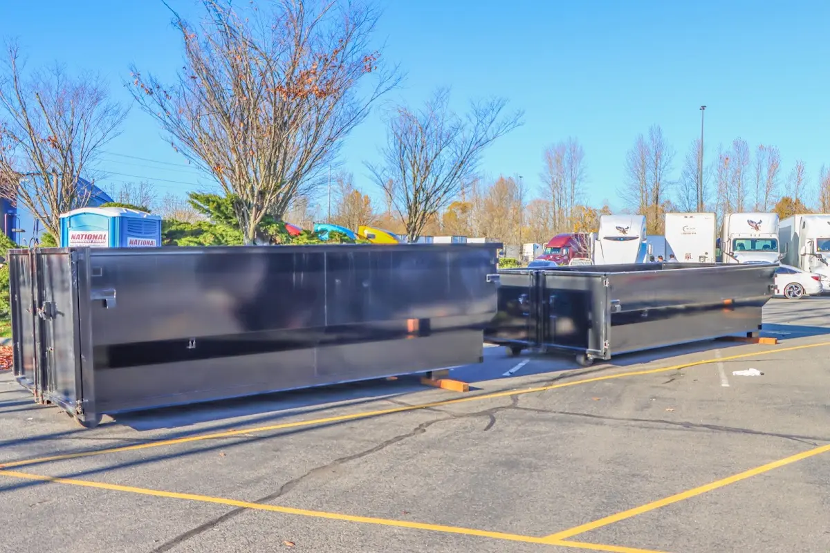 Professional dumpster rental service with roll-off container on residential driveway in Webster Groves